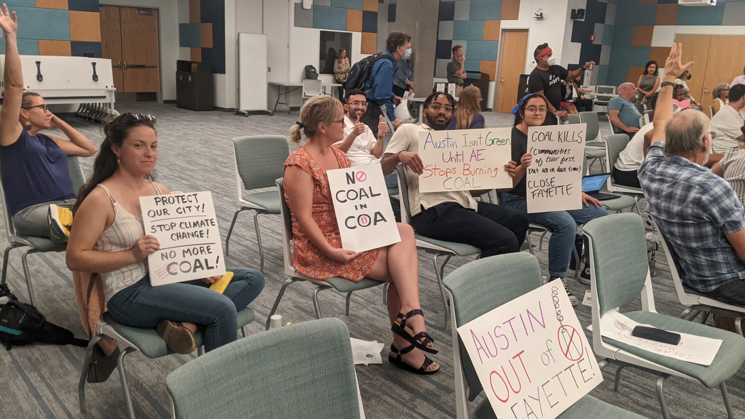 Austin residents demand an end to burning goal at an Austin Energy public meeting on August 29, 2023.