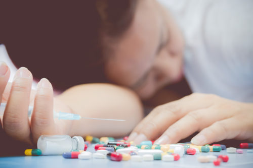 overdose-close-pills-addict-lying-on